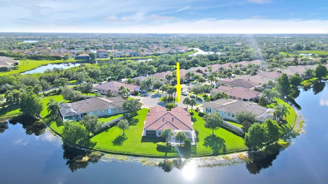 an aerial view of residential houses with outdoor space and parking