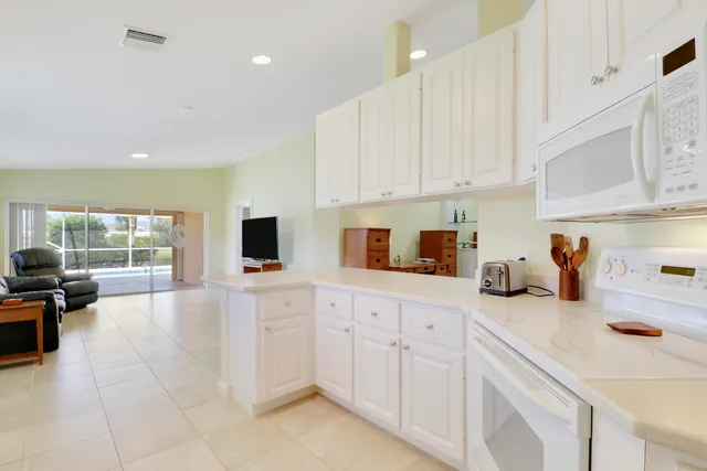 a kitchen with cabinets and window