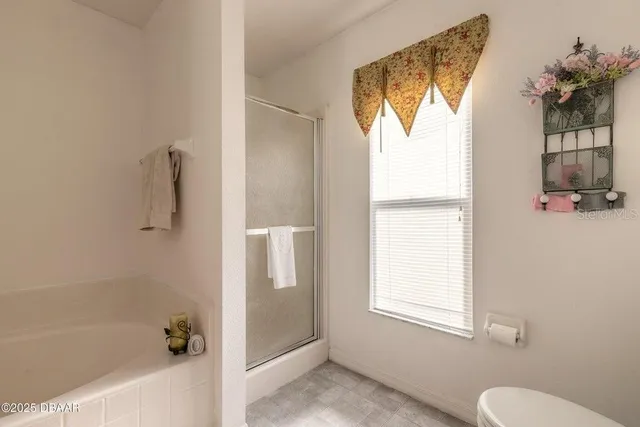 a bathroom with a window and a shower