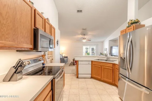 a kitchen with a stove a sink and a refrigerator