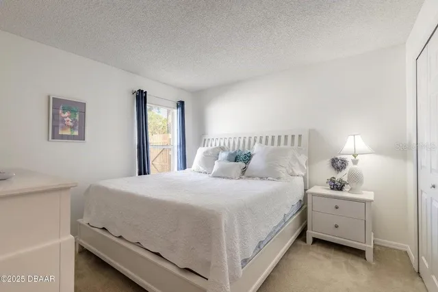 a bedroom with a bed and a night stand