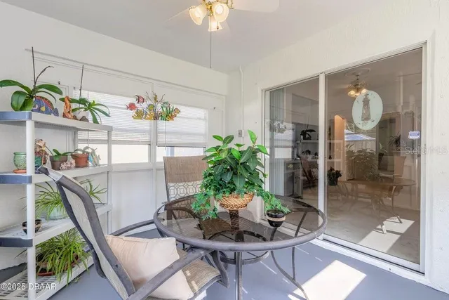 a dining room with furniture potted plants and wooden floor
