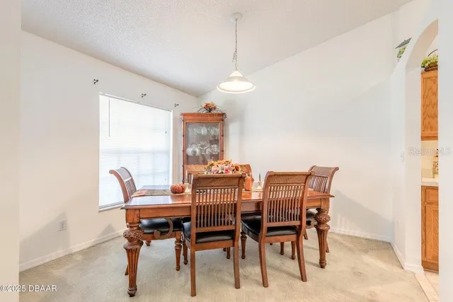 a dining room with furniture and window