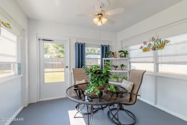 a dining room with furniture a potted plant and a chandelier