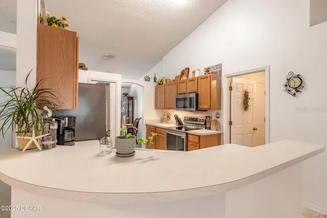 a kitchen with a appliances and cabinets