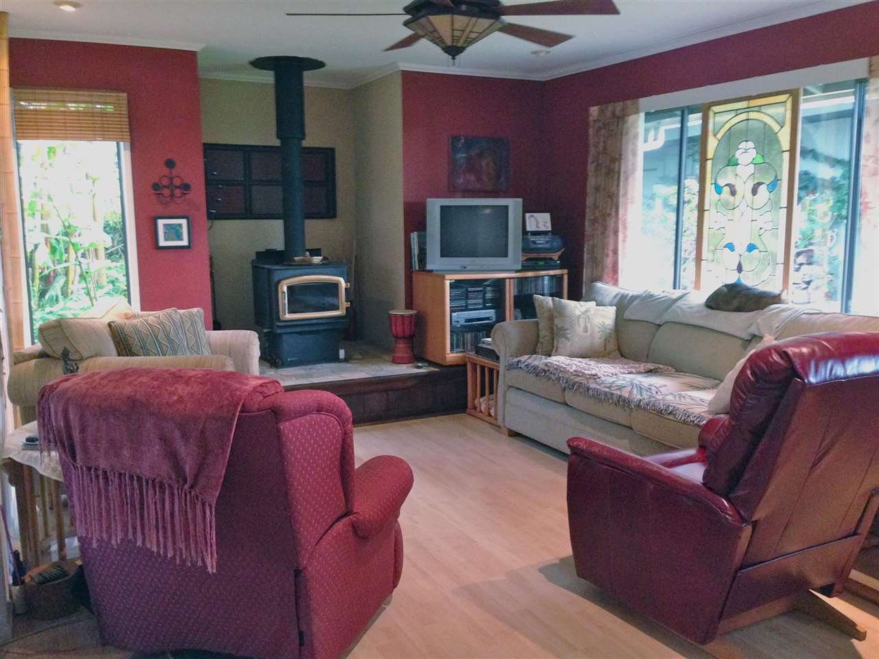 339 Ainakula Road Kula, HI 96790 - Photo 20 of 20 a living room with furniture a flat screen tv and a fireplace