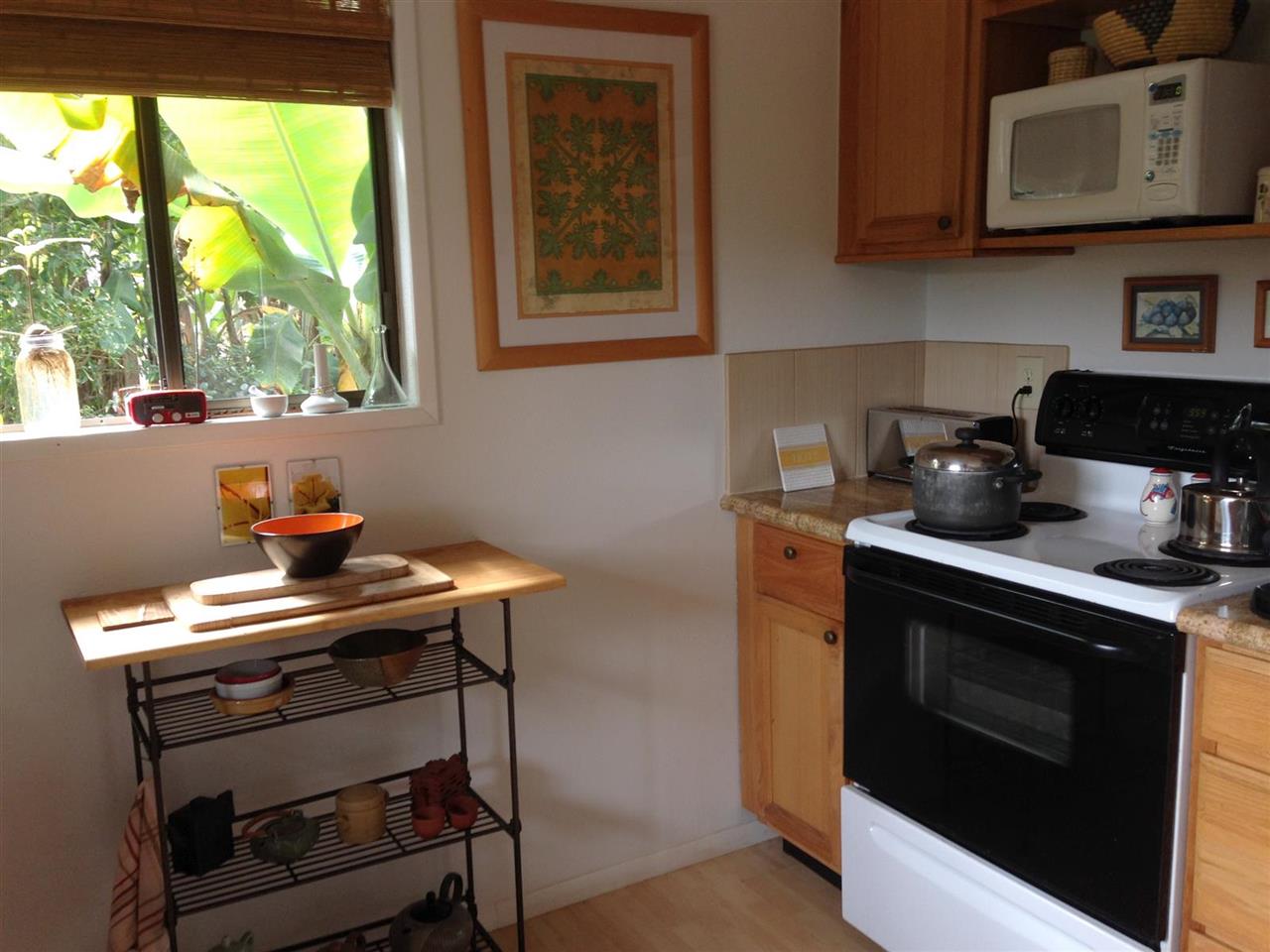339 Ainakula Road Kula, HI 96790 - Photo 5 of 20 a kitchen with stainless steel appliances a stove a sink and a microwave