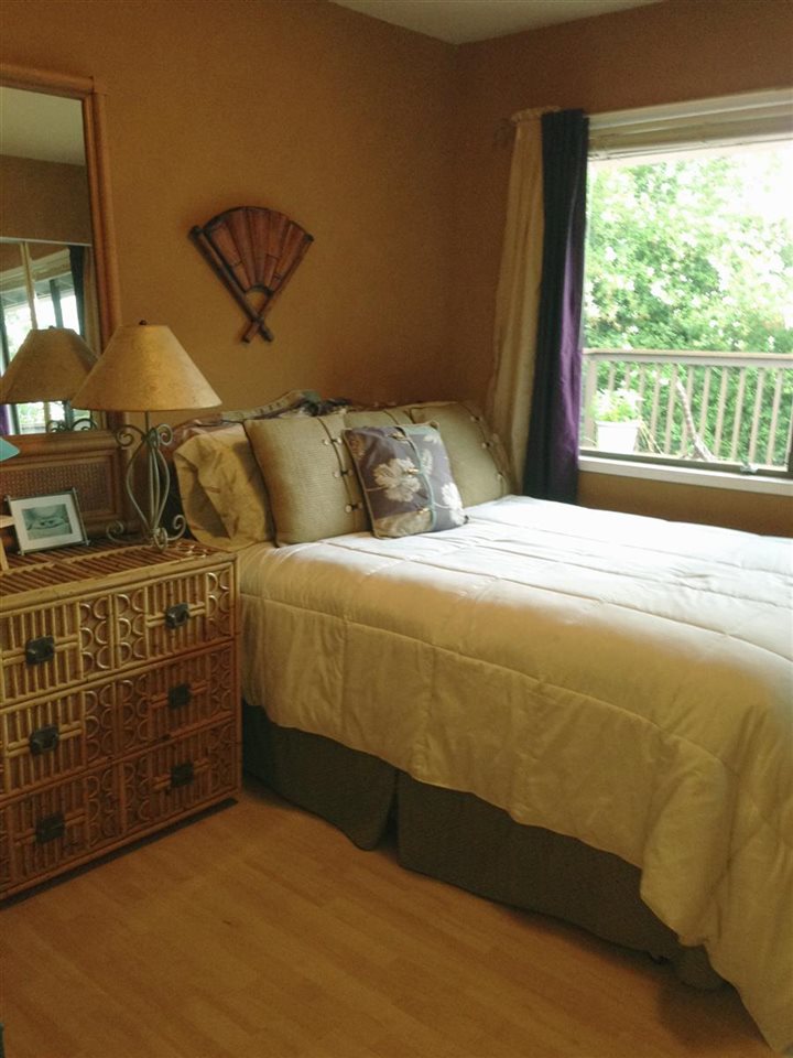 339 Ainakula Road Kula, HI 96790 - Photo 8 of 20 a bedroom with a bed and a chandelier