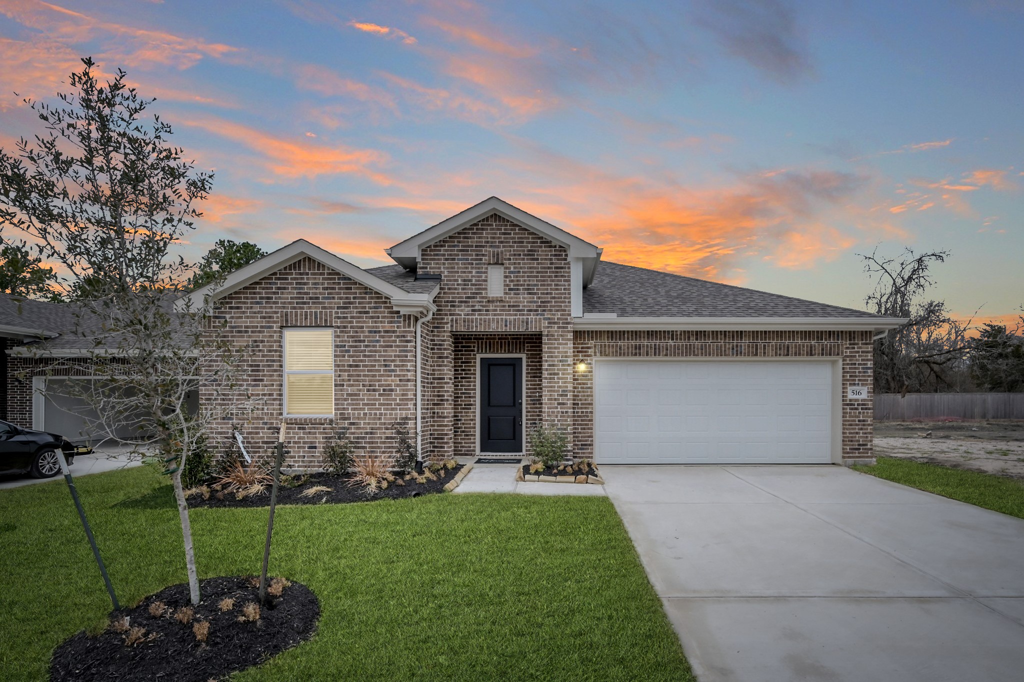 516 Monarch Trail Huntsville, TX 77340 - Photo 1 of 20 a front view of a house with a garden and plants