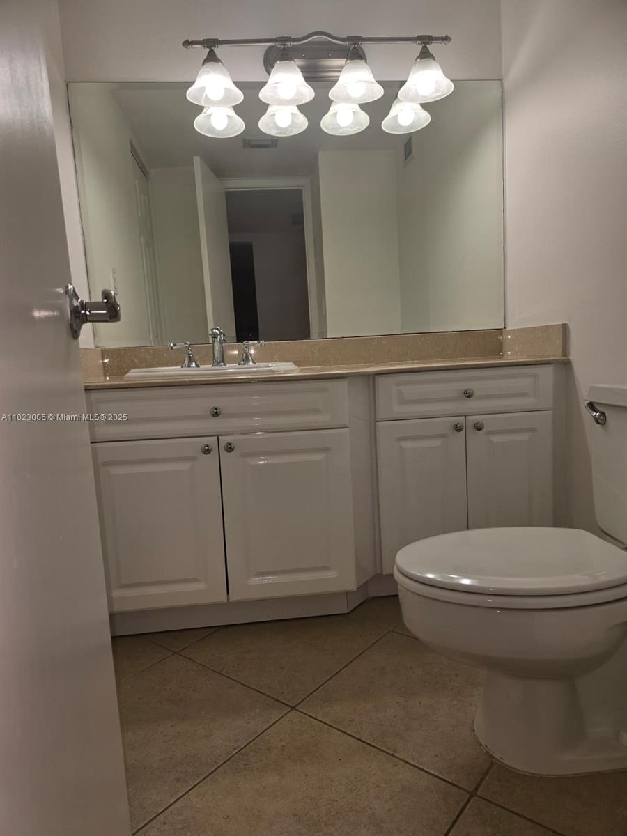 Brickell Place Miami, FL 33129 - Photo 12 of 24 a bathroom with a toilet sink and mirror