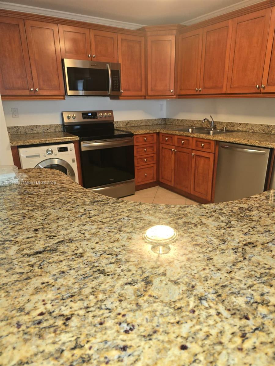 Brickell Place Miami, FL 33129 - Photo 14 of 24 a kitchen with granite countertop a sink a stove top oven and granite counter top