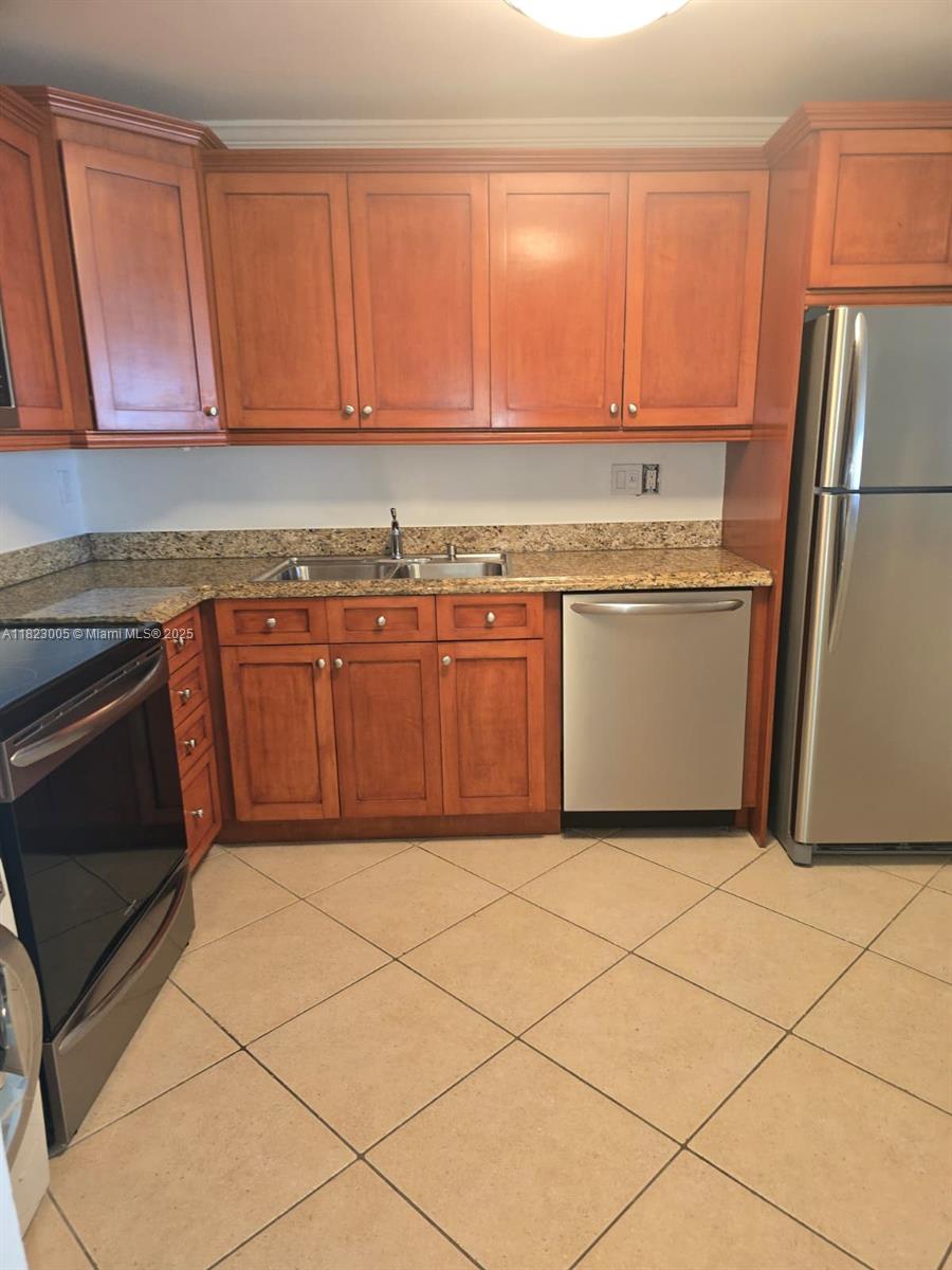 Brickell Place Miami, FL 33129 - Photo 15 of 24 a kitchen with granite countertop a refrigerator and a sink
