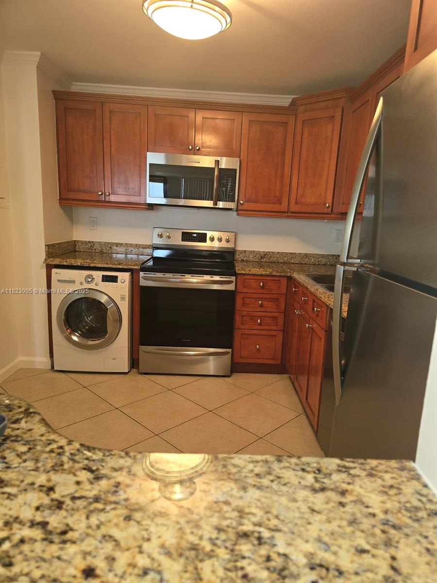 Brickell Place Miami, FL 33129 - Photo 16 of 24 a kitchen with a stove top oven and cabinets