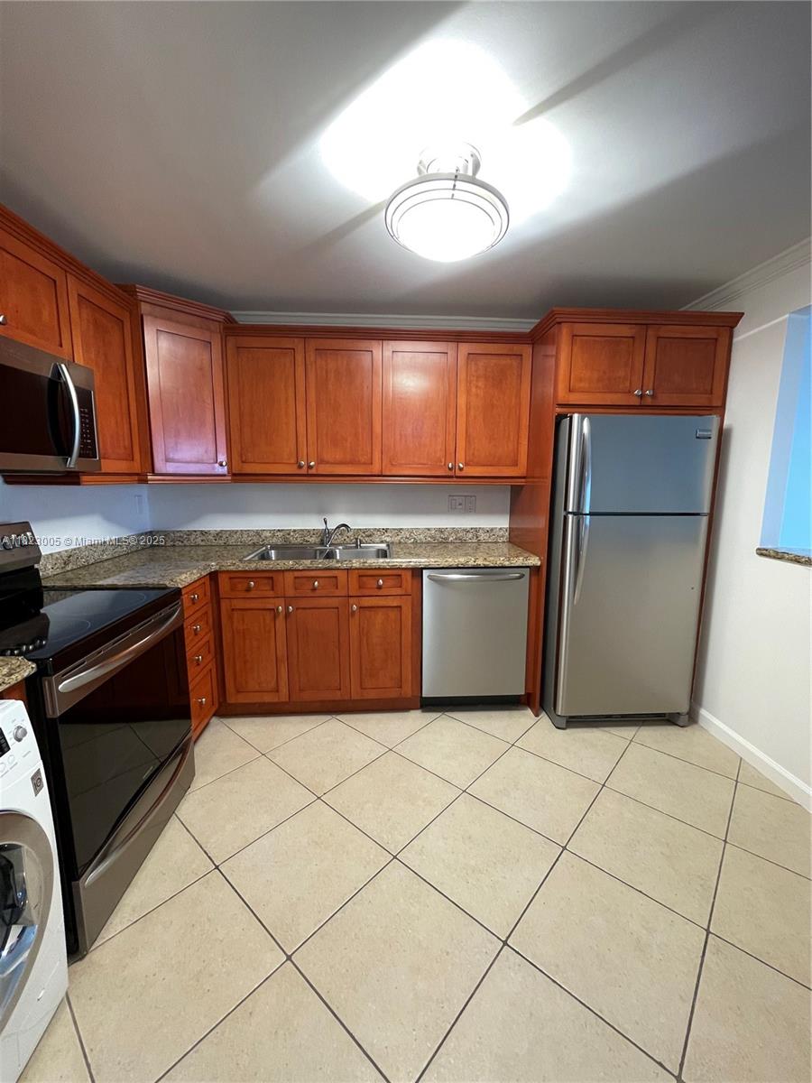 Brickell Place Miami, FL 33129 - Photo 20 of 24 a kitchen with stainless steel appliances granite countertop a refrigerator sink and cabinets