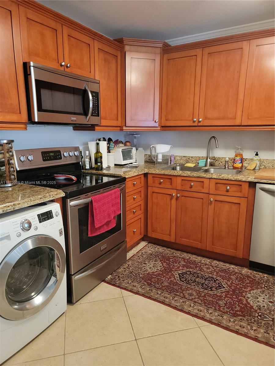 Brickell Place Miami, FL 33129 - Photo 2 of 24 a kitchen with stainless steel appliances granite countertop a stove microwave and sink