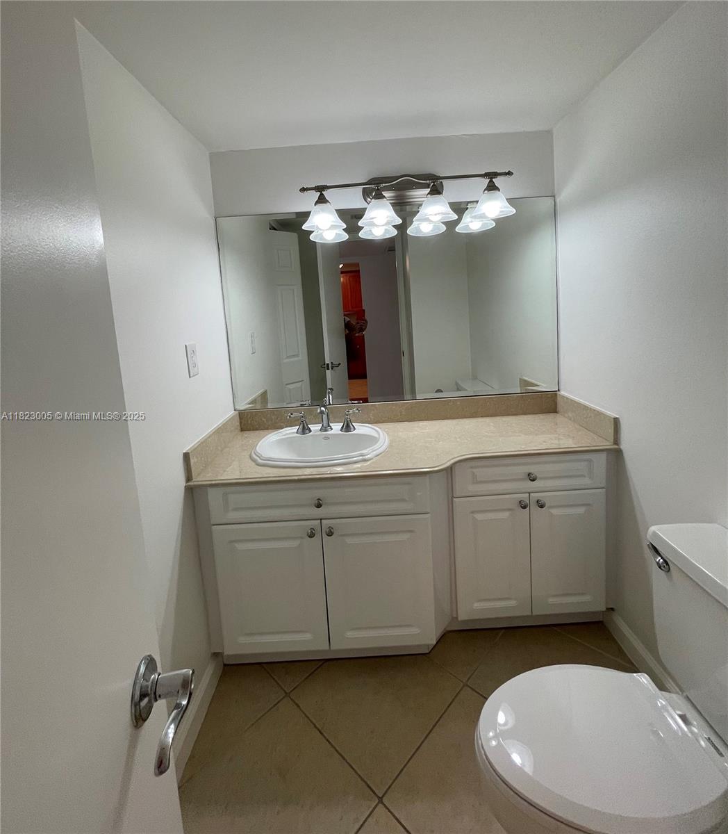Brickell Place Miami, FL 33129 - Photo 23 of 24 a bathroom with a sink vanity granite and toilet