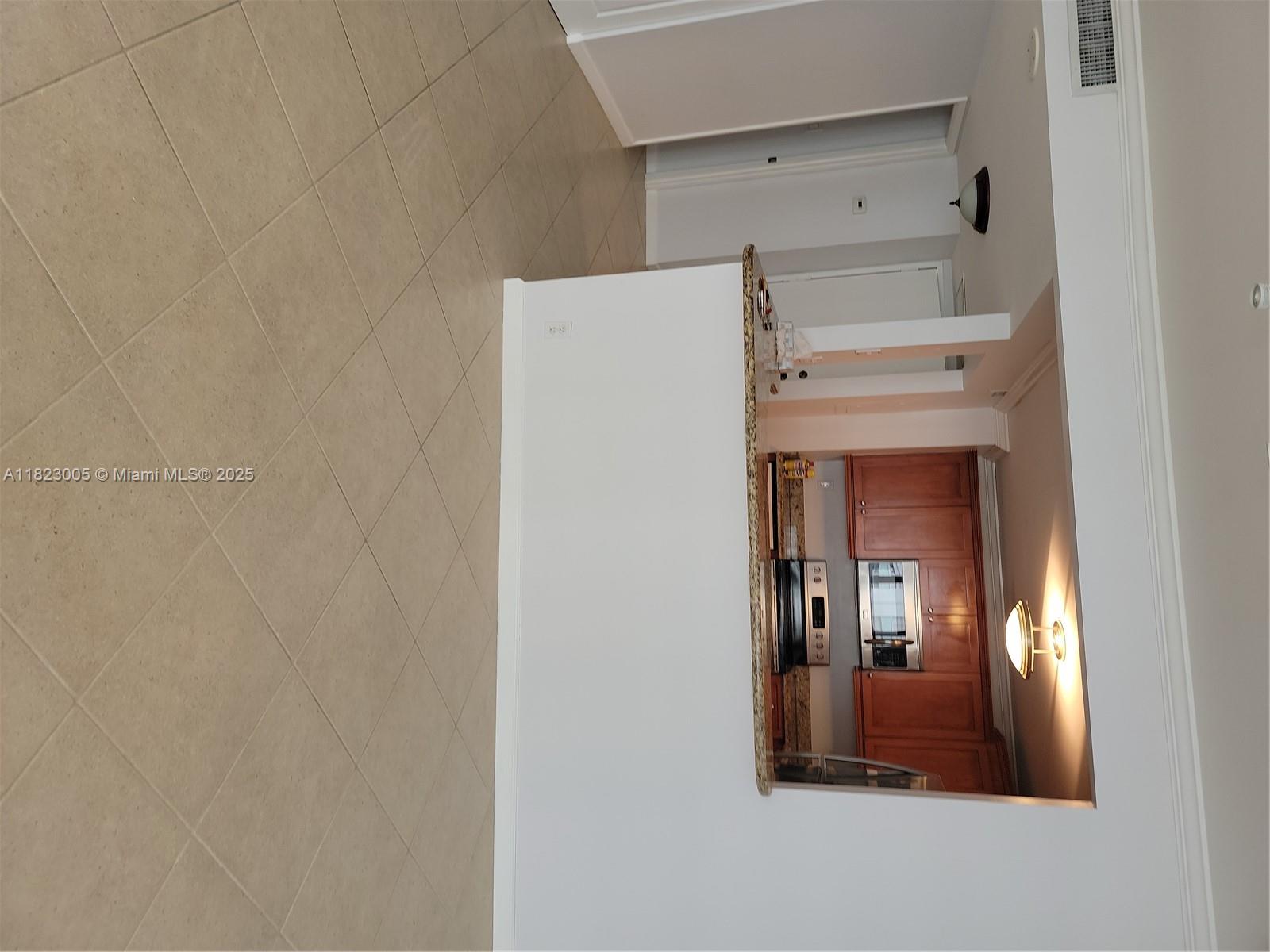 Brickell Place Miami, FL 33129 - Photo 4 of 24 a view of a hallway with wooden cabinets