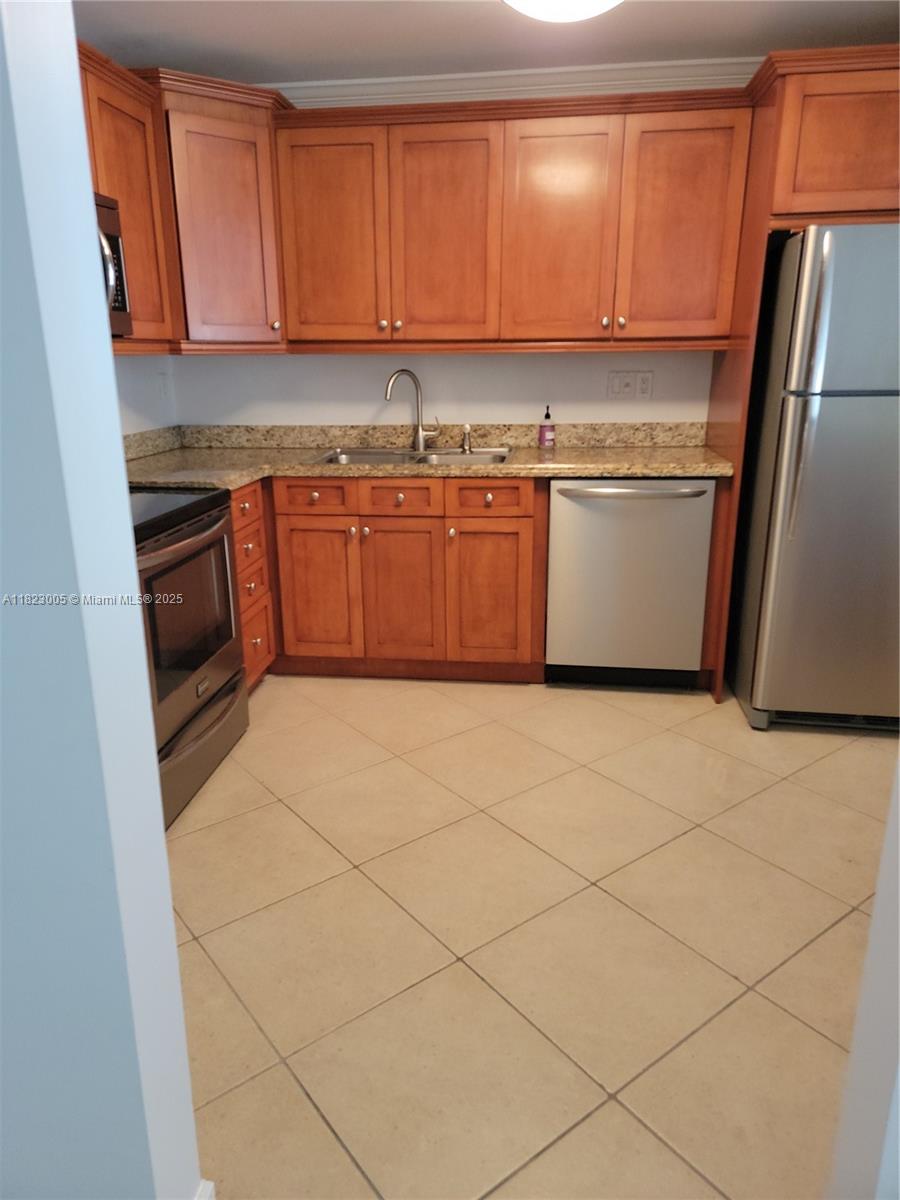 Brickell Place Miami, FL 33129 - Photo 5 of 24 a kitchen with stainless steel appliances granite countertop a stove a sink and a refrigerator