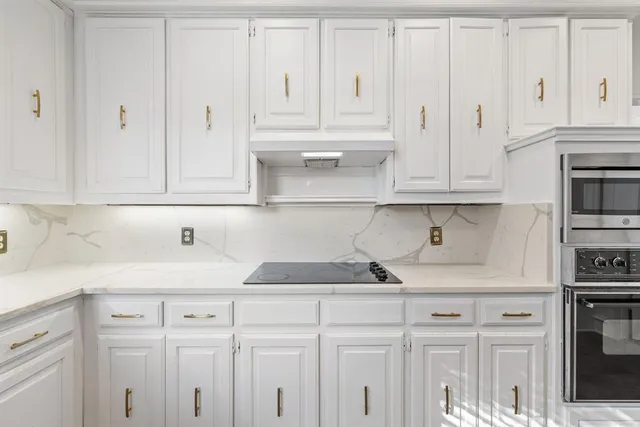 a kitchen with white cabinets and a sink