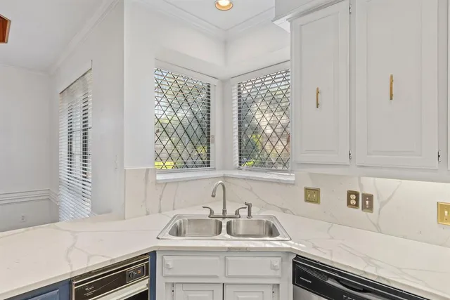a kitchen with a sink and cabinets