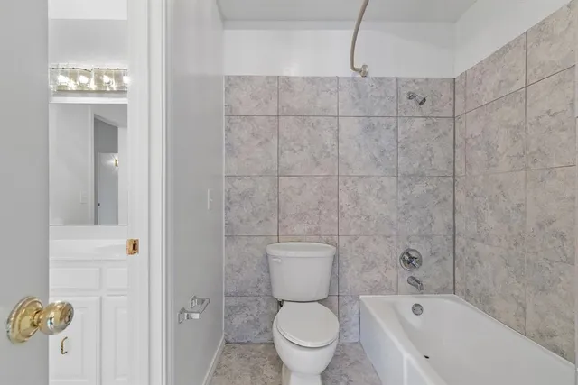 a bathroom with a toilet and a shower
