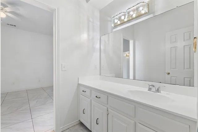 a bathroom with a double vanity sink and a mirror