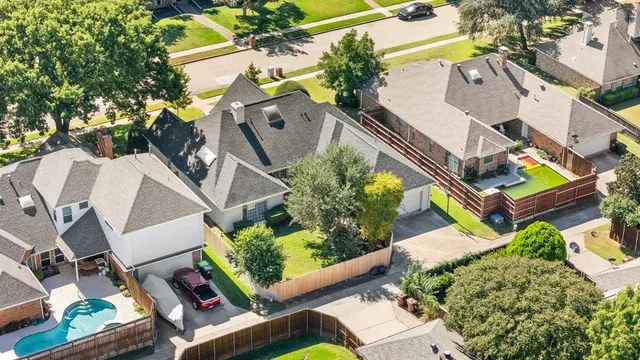 an aerial view of residential houses with outdoor space