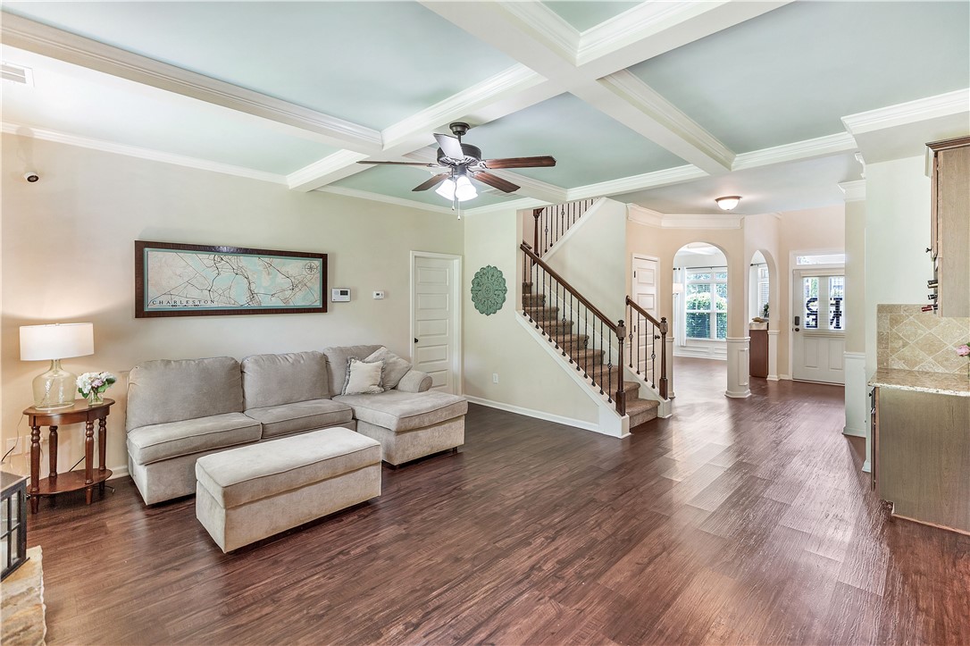 144 Buckland Drive Anderson, SC 29621 - Photo 39 of 48 Rich hardwood floors flow through this welcoming living space, leading to a grand staircase and elegant arched doorways.