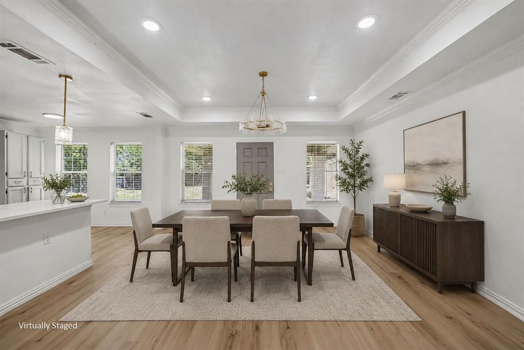 307 Dixon Street Terrell, TX 75160 - Photo 13 of 32 Dining area featuring wood-finish flooring, recessed lighting, and a tray ceiling