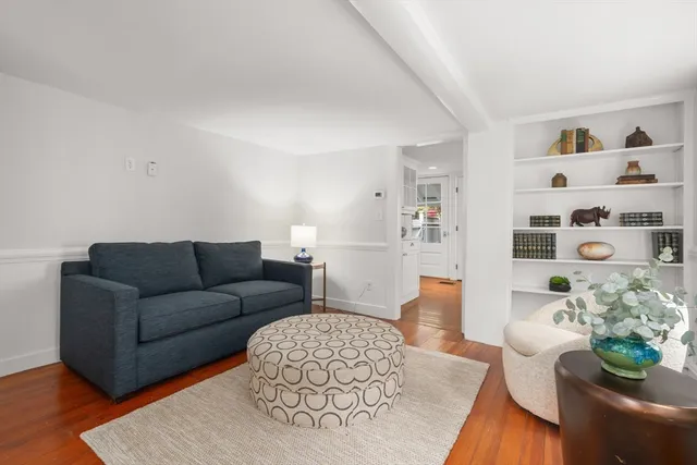 a living room with furniture and flowers