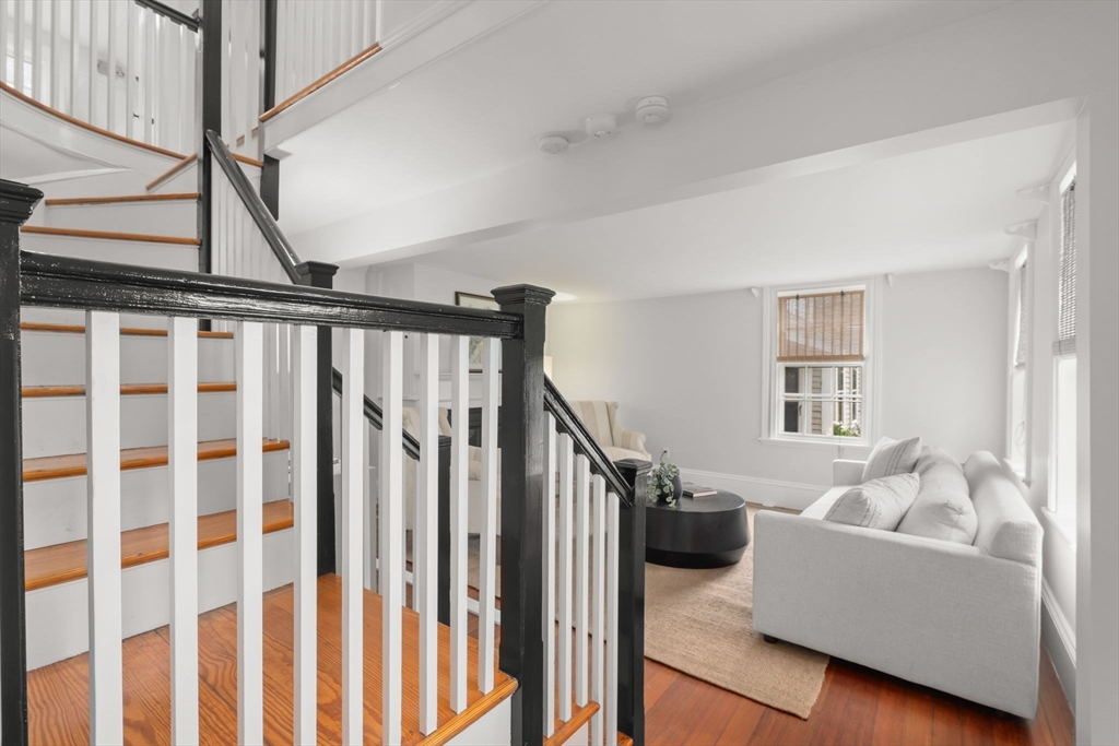 165 Highland Street, Unit 165 Dedham, MA 02026 - Photo 19 of 40 a livingroom with furniture staircase and a living room