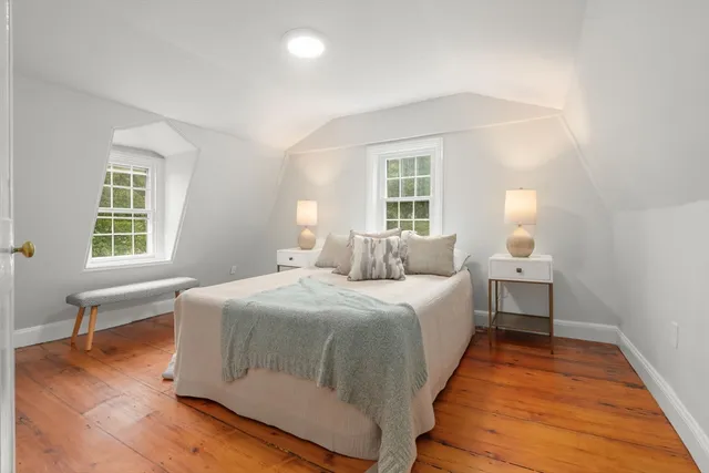 a bedroom with a bed and a night stand