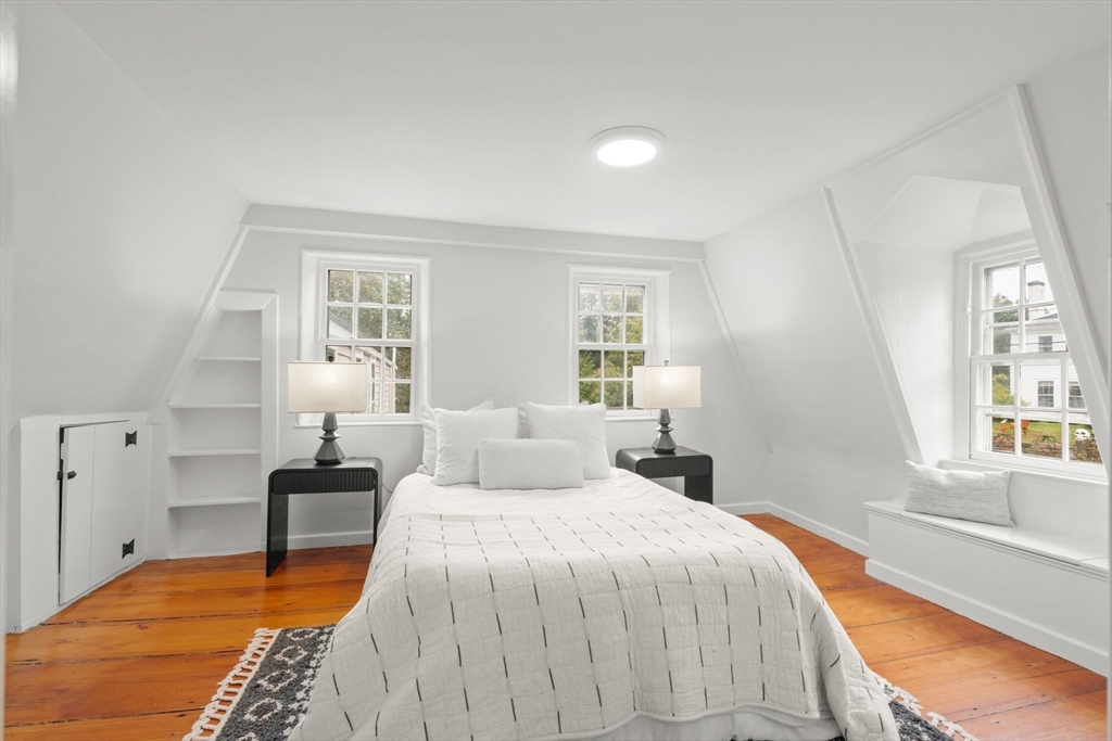 165 Highland Street, Unit 165 Dedham, MA 02026 - Photo 26 of 40 a bedroom with a bed and a window