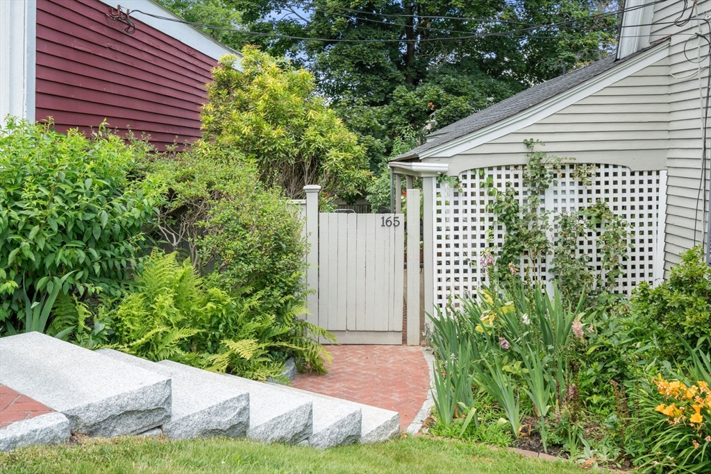 165 Highland Street, Unit 165 Dedham, MA 02026 - Photo 3 of 40 a front view of a house with garden