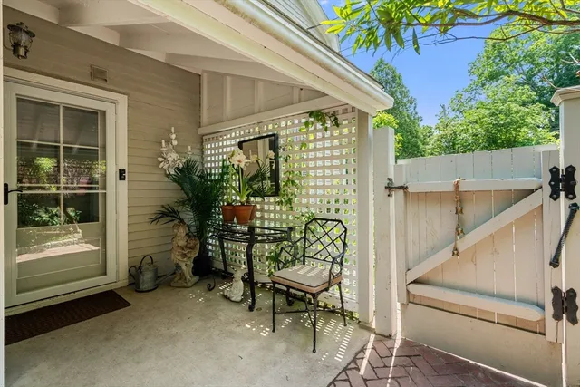 a view of a porch with chairs and a potted plant