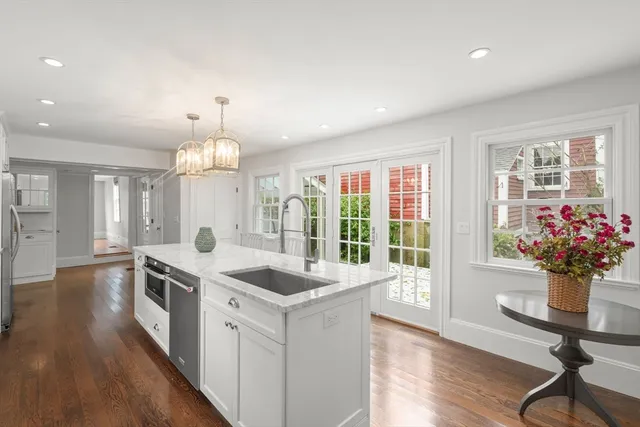 a view of a kitchen island wooden floor and living room
