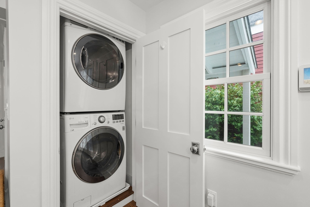 165 Highland Street, Unit 165 Dedham, MA 02026 - Photo 9 of 40 a view of a hallway with washer and dryer