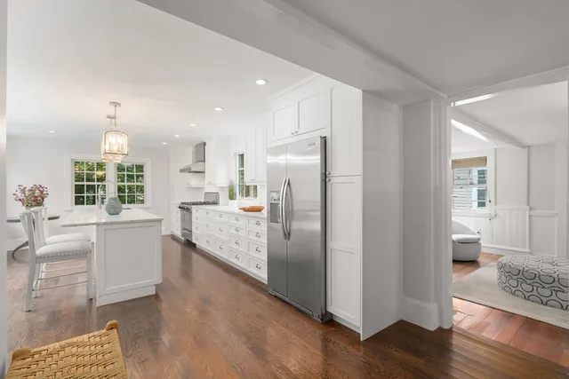 a kitchen with stainless steel appliances granite countertop a refrigerator a sink and a stove