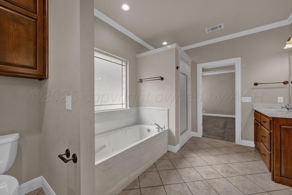 6607 Sumac Place Amarillo, TX 79124 - Photo 15 of 33 a spacious bathroom with a granite countertop sink toilet and shower