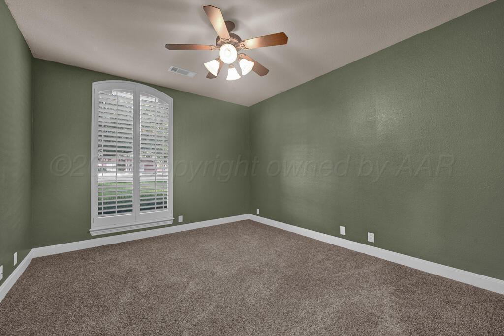 6607 Sumac Place Amarillo, TX 79124 - Photo 20 of 33 an empty room with windows and chandelier fan