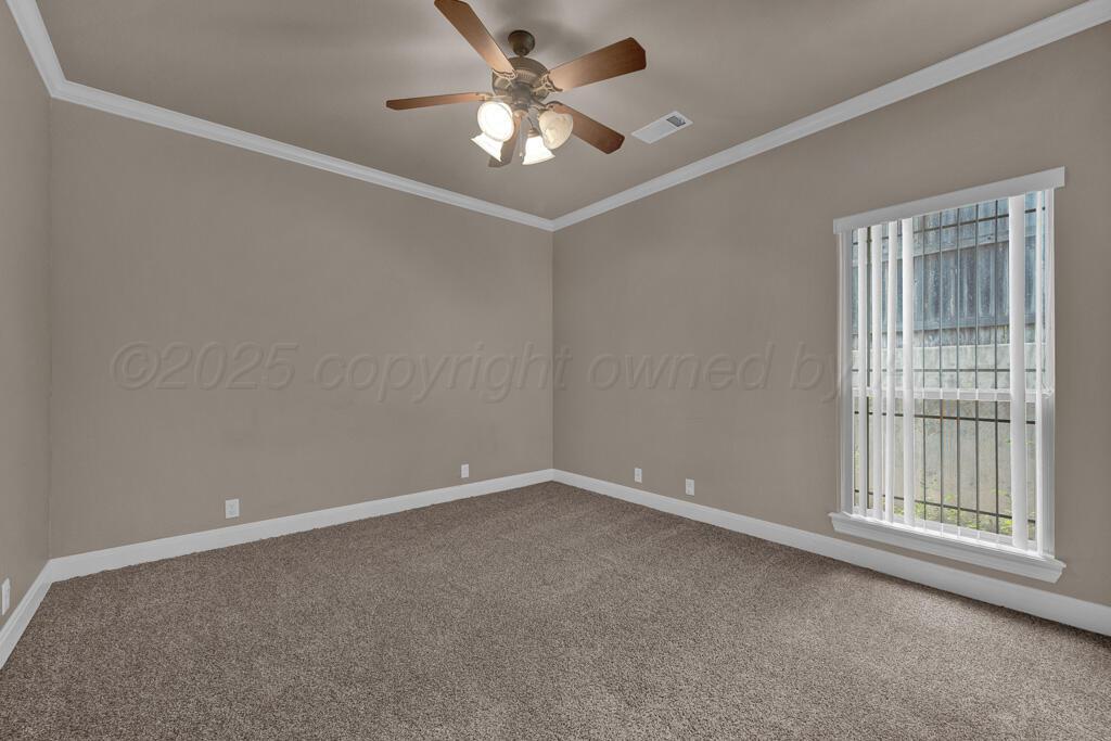 6607 Sumac Place Amarillo, TX 79124 - Photo 24 of 33 an empty room with a chandelier fan and windows
