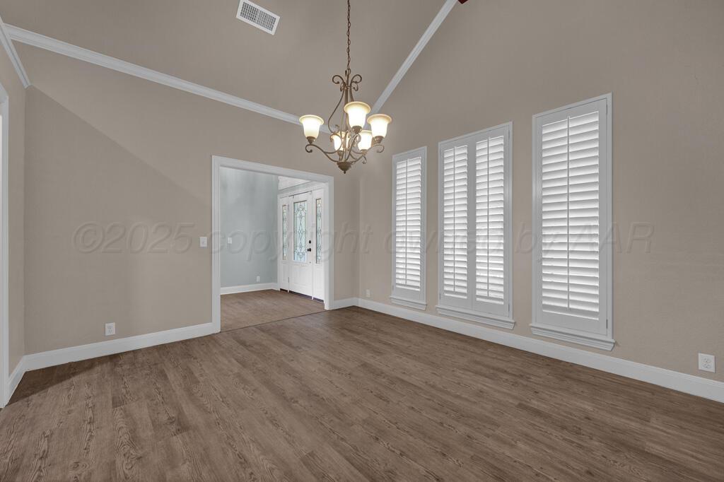 6607 Sumac Place Amarillo, TX 79124 - Photo 5 of 33 a view of an empty room with wooden floor and a window