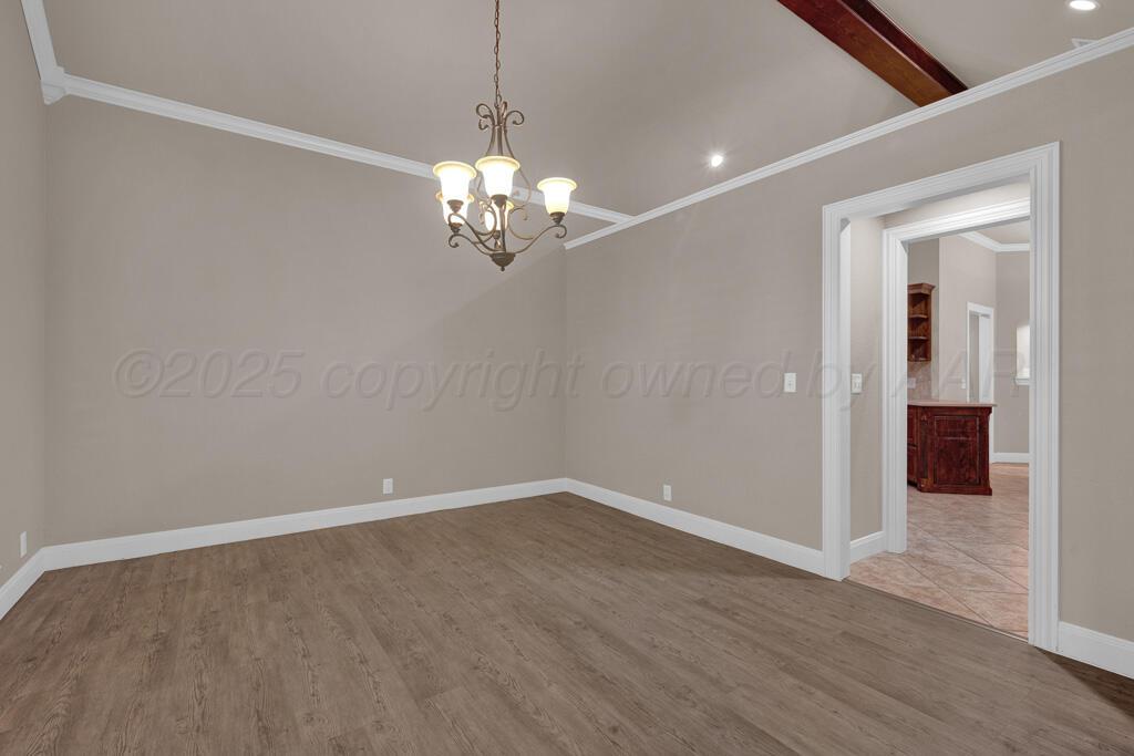 6607 Sumac Place Amarillo, TX 79124 - Photo 6 of 33 wooden floor in an empty room with a window