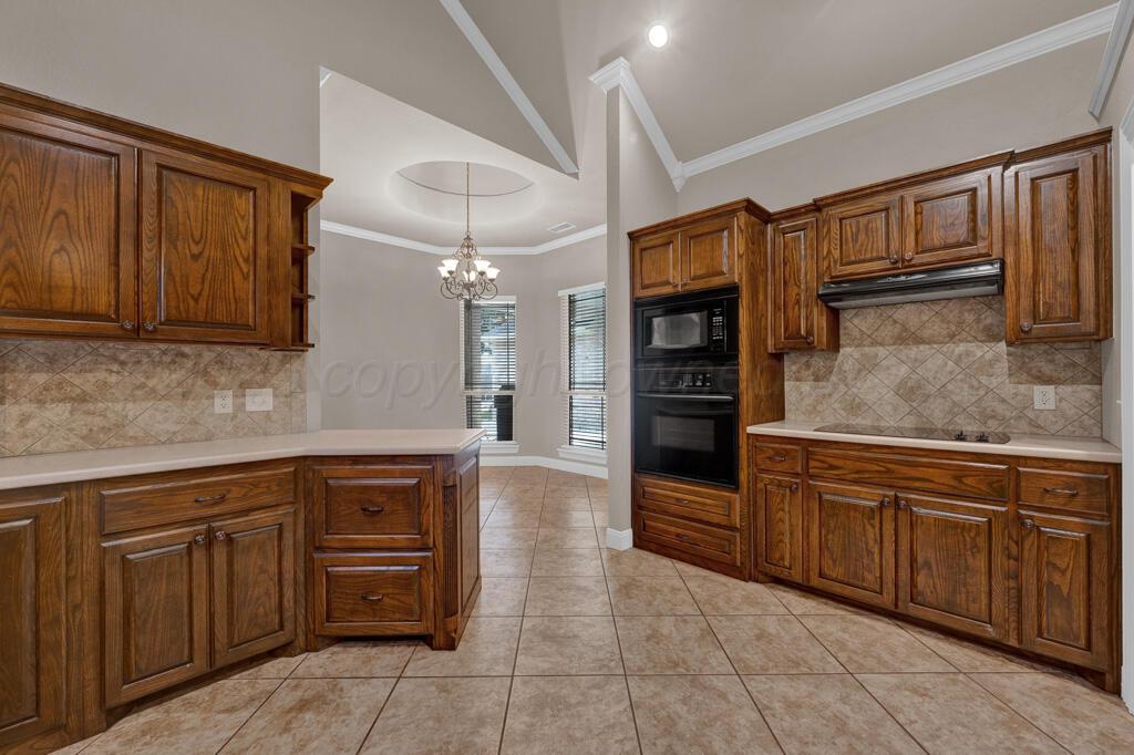 6607 Sumac Place Amarillo, TX 79124 - Photo 9 of 33 a kitchen with stainless steel appliances granite countertop a refrigerator and a sink