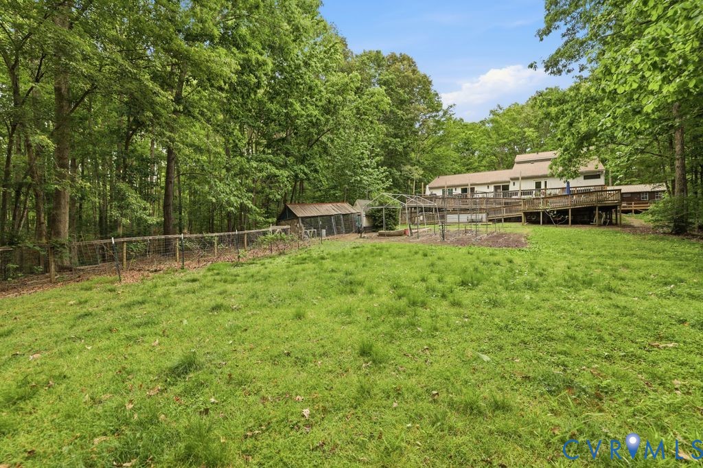 1061 Turkey Ridge Drive Moseley, VA 23120 - Photo 39 of 51 a backyard of a house with table and chairs