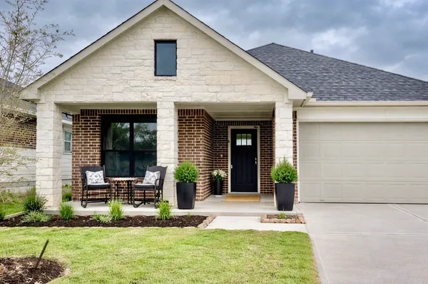 a view of the house with backyard porch and sitting area