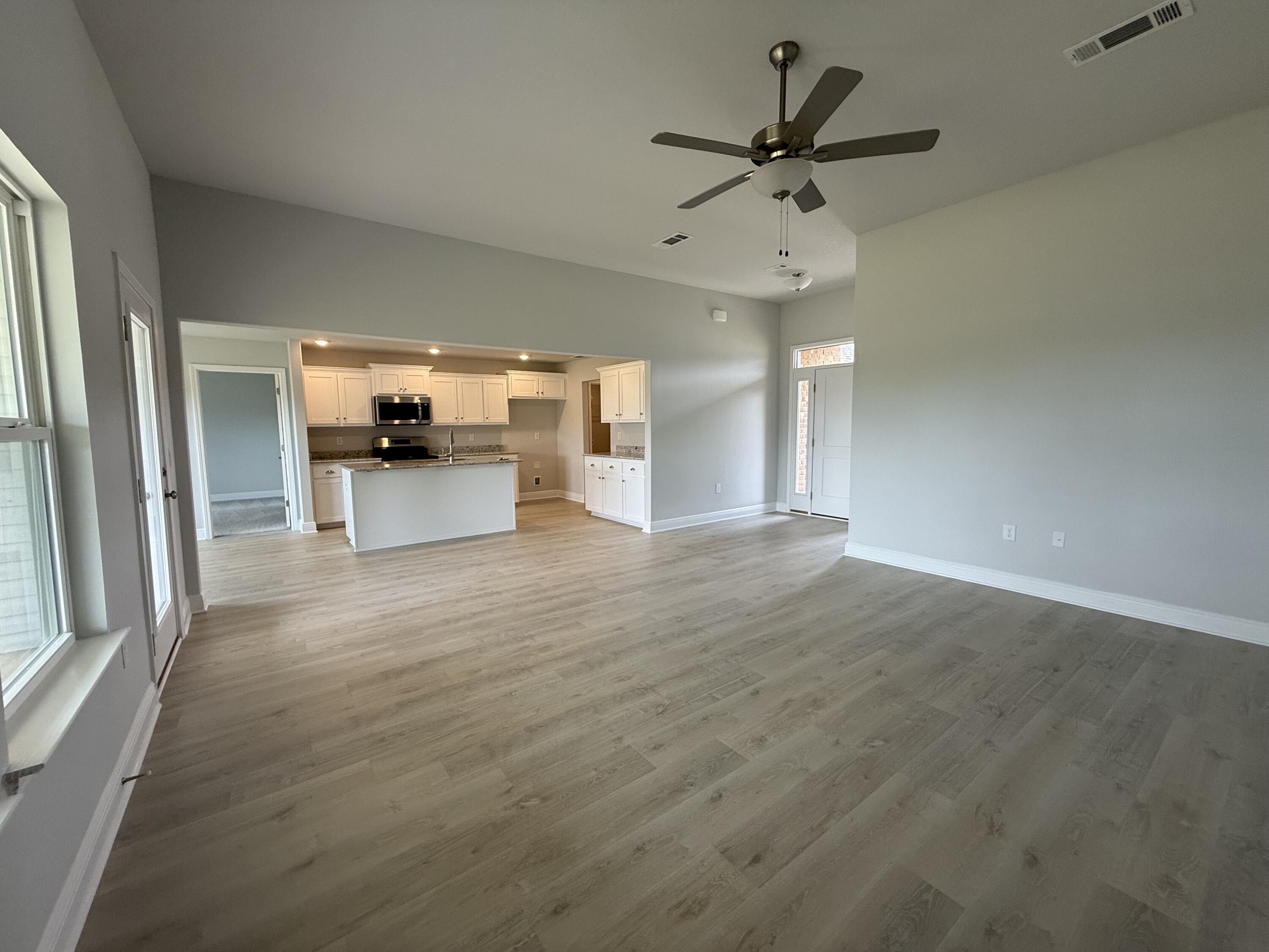 6002 Crocket Cove Crestview, FL 32539 - Photo 15 of 29 wooden floor in an empty room with a window