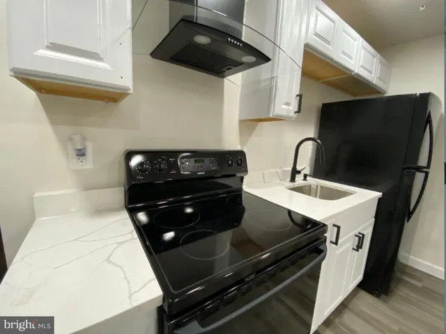 a kitchen with a sink appliances and cabinets