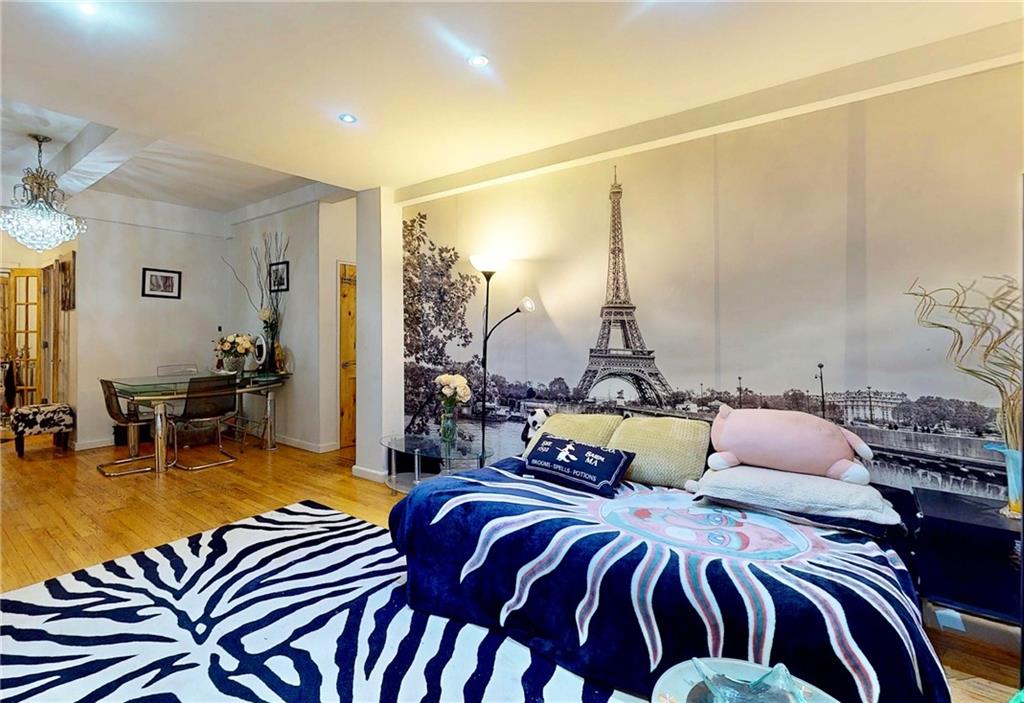 2546 East 13th Street, Unit L14 Brooklyn, NY 11235 - Photo 3 of 10 a bedroom with two beds and a lamp with potted plant