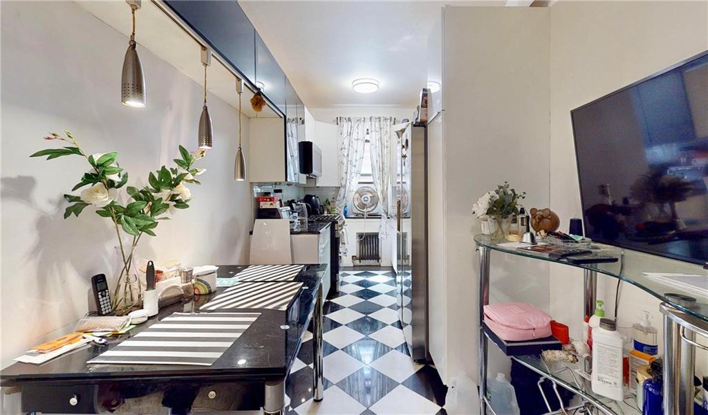 2546 East 13th Street, Unit L14 Brooklyn, NY 11235 - Photo 10 of 10 a living room with furniture and a potted plant